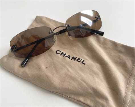 chanel sunglasses that say chanel on the side|Chanel rimless sunglasses.